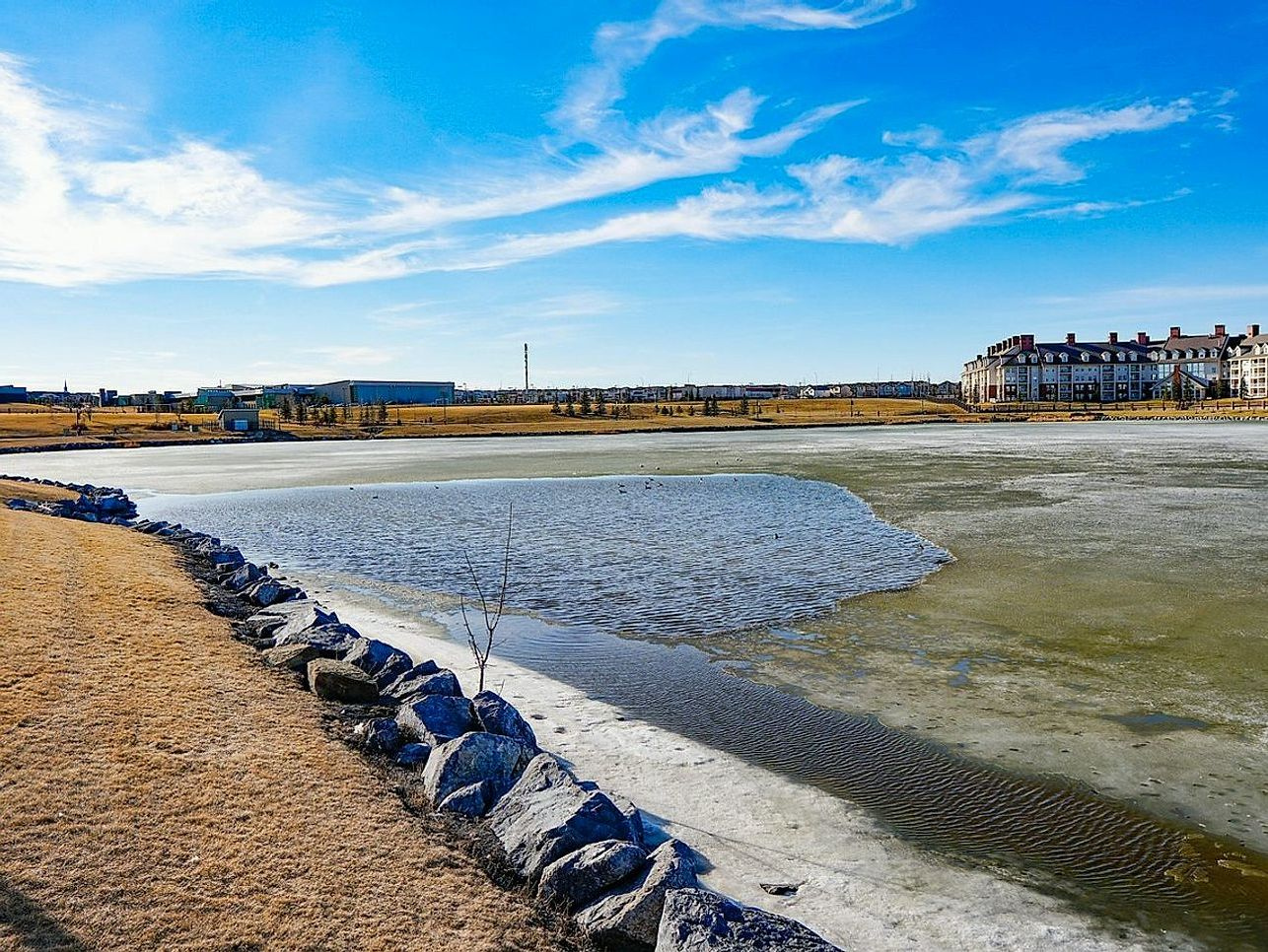 Un lago bajo el hielo visto desde la orilla en invierno